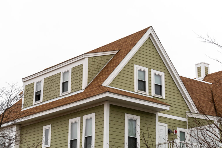roofing edgewater fl Exterior view of a newly built family house with shed dormer windows on a winter day in Brighton, MA, USA