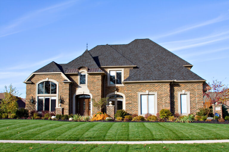 roofing citrus springs fl A large American brick home with many roof angles and windows.