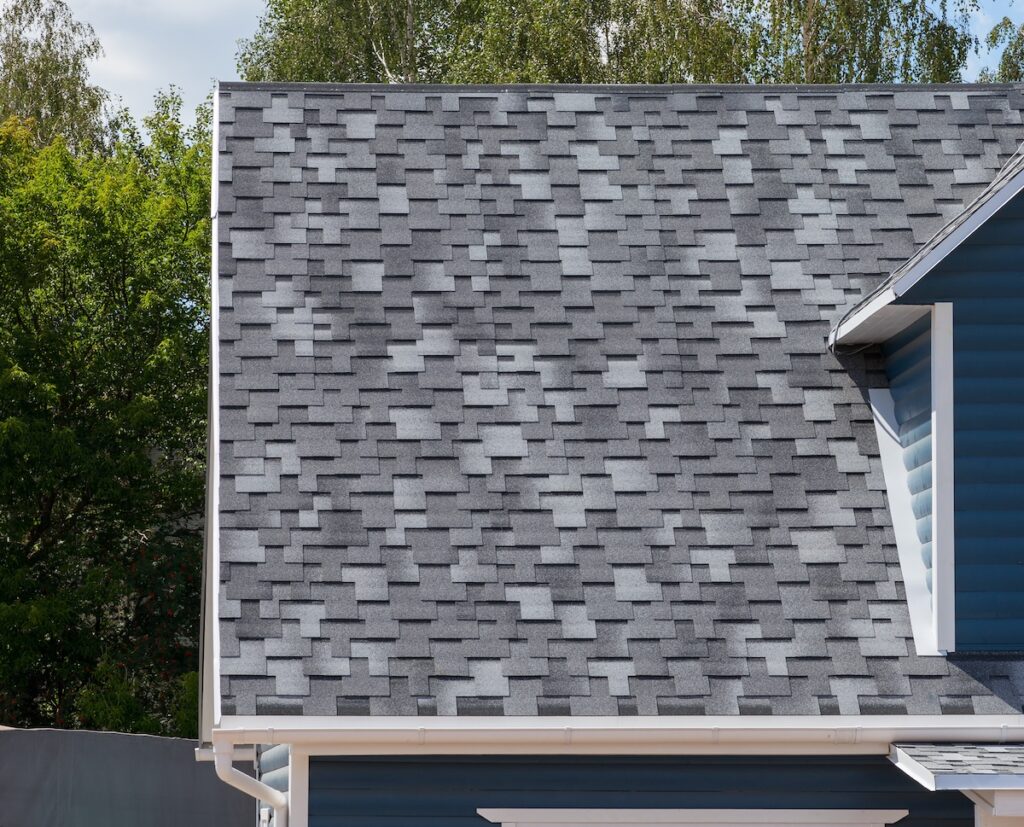 architectural shingles vs 3-tab The roof of the house lined with gray bitumen shingles