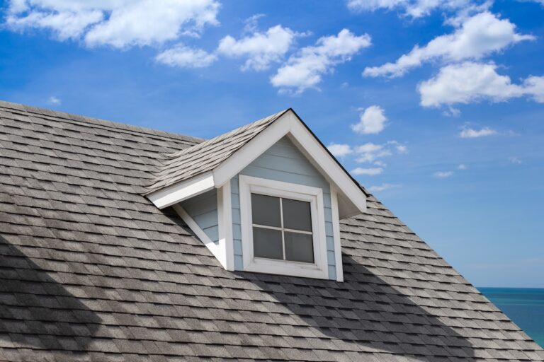 grey roof shingle with with garret house. house roof near sea in morning time.