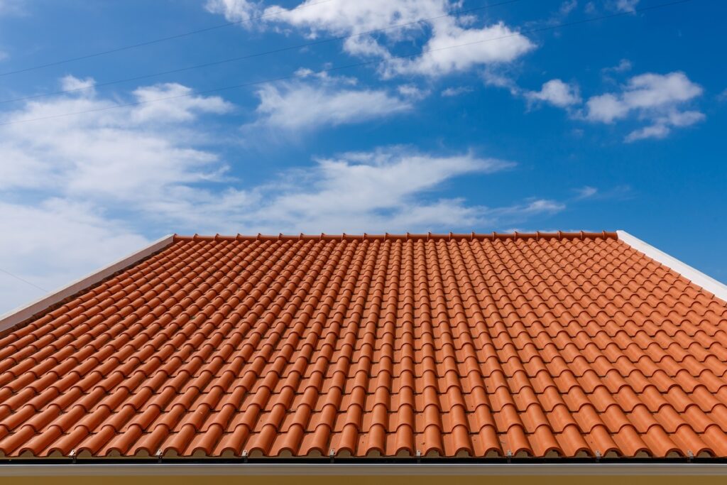 tile roof cost Red tiles panels roof under blue sky