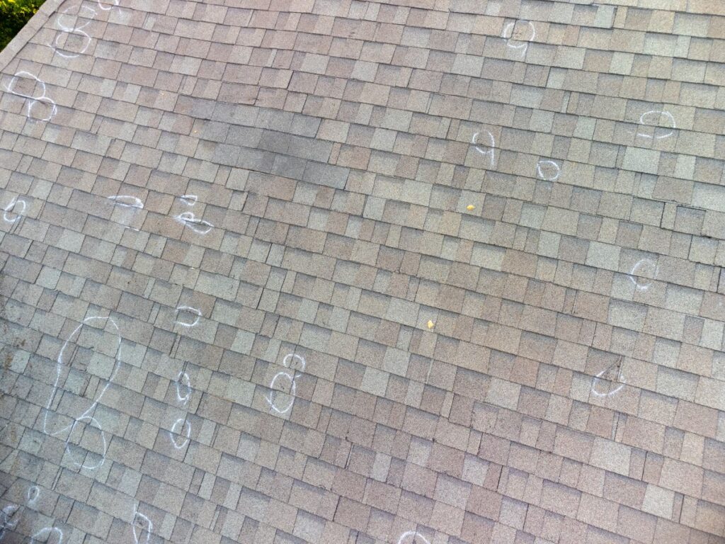 Roof with hail damage and markings from inspection
